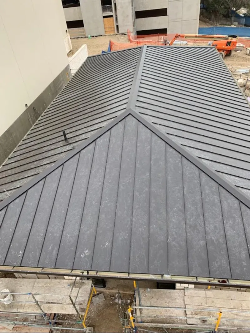 Commercial metal roof construction with crane equipment in Lebanon